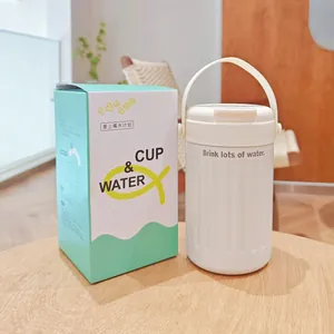 White insulated water cup with handle and its matching green and white packaging box