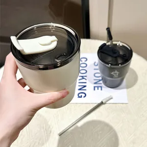 Close-up of a minimalist white stainless steel coffee cup with a dual-drinking lid