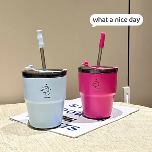 Close-up of minimalist stainless steel coffee cups with straws and colorful lids