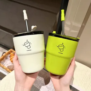 Detail view of minimalist stainless steel coffee cups with straws and lids