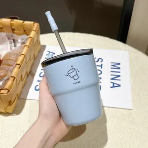 Close-up of a minimalist light blue stainless steel coffee cup with a metal straw