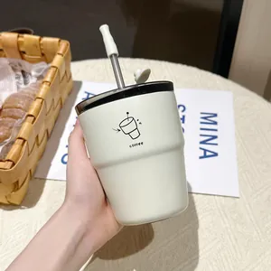 White stainless steel coffee cup with straw and minimalist doodle in handheld view