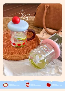 Detailed view of colorful dopamine glass cups with handles featuring lemon slices and ice