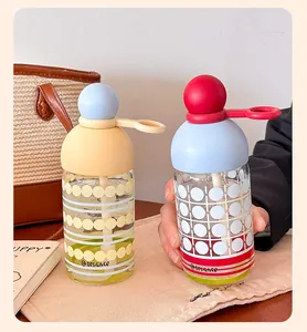 Pair of creative borosilicate glass water bottles with colorful ball lids and straws