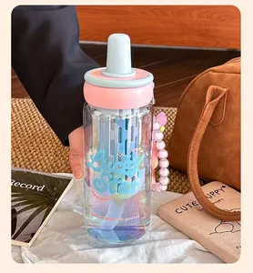 Close-up view of a high-aesthetic glass water bottle with a built-in tea infuser and straw