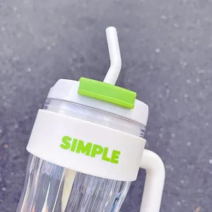 Close-up view of minimalist straw cup with SIMPLE text and green lid detail