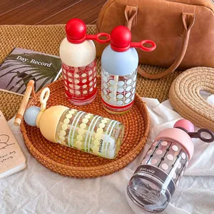 Stylish portable borosilicate glass water bottles with integrated straws and colorful lids