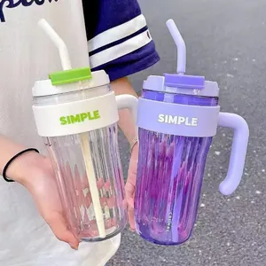 Detailed macro view of stylish plastic water cups with straws and side handles for daily use
