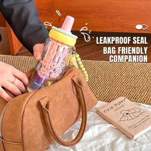 Aesthetic glass water bottle with straw and filter being put into a brown bag