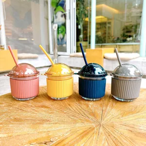 Set of four colorful glass straw cups with cute egg-shaped lids and protective silicone sleeves