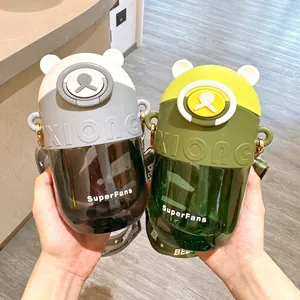 Close-up of cute Tritan bear-shaped children's water bottles with straws and straps.