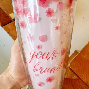 Gros plan d'un gobelet en plastique à double paroi avec motif fleur de cerisier