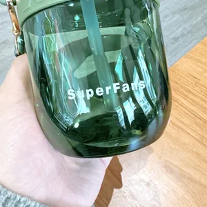 Detailed close-up view of green Tritan children straw water bottle with SuperFans print