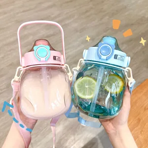 Detail of cute big-belly water bottles with straw and strap in pink and blue colors