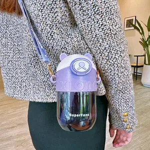 Detail view of purple bear straw cup with a portable shoulder strap for kids