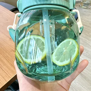 Detailed macro shot of a mint green belly water bottle with tea infuser and fresh lemon slices inside