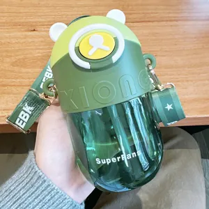 Close-up of green bear-shaped Tritan straw water bottle with carrying strap.
