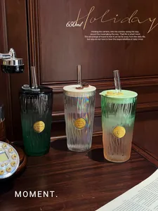 Aesthetic gradient glass cups with straws shown in a warm vintage wooden interior setting