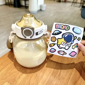 Close-up detail of a transparent amber big belly water bottle with cute space stickers