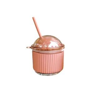 Cute egg-shaped glass water cup with straw and pink heat-resistant silicone sleeve