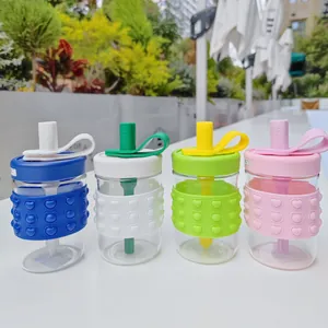 Close-up of four colored glass water bottles with heart patterned silicone protection.