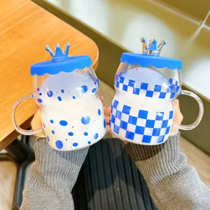 Klein blue glass mugs with crown lids, featuring polka dot and checkerboard patterns.