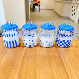 Detail showing four Klein blue glass cups with unique patterns and silver crown lids.