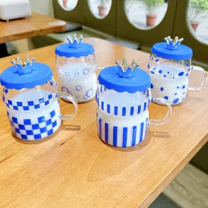 Klein blue glass mugs with silver crown silicone lids and assorted geometric patterns