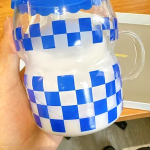 Detailed view of Klein blue checkerboard glass cup with a creative crown-shaped lid