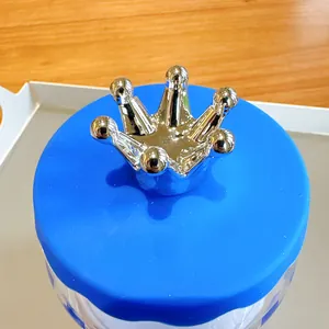 Macro detail of a Klein blue cup lid with a silver metallic crown ornament