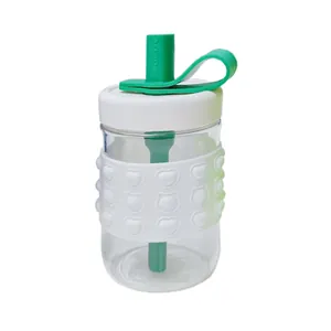 Minimalist transparent glass water bottle with white silicone heart sleeve and green straw