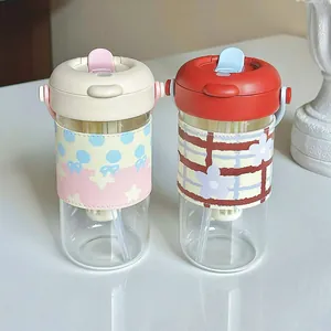 Two portable heat-resistant glass bottles with tea infuser and dual-drinking lids.