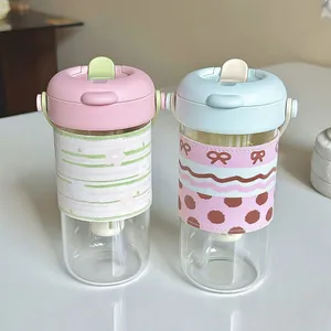 Portable heat-resistant glass tea tumbler with dual-drink straw lid and sleeve