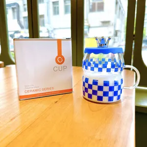 Klein Blue checkered glass cup with a decorative crown lid and handle detail.