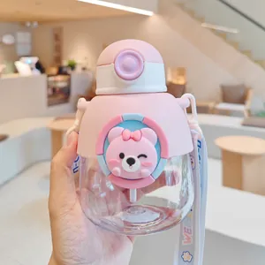 Detailed view of pink children's portable water bottle with cute bear design and straw