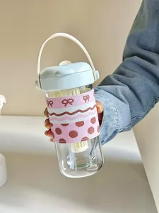 Portable glass water bottle with tea infuser, straw, and cute pink patterned sleeve