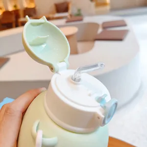 Detail view of the open lid and straw on a cute green children's belly water bottle