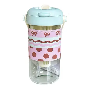 High-value glass water bottle with tea infuser, dual-drinking lid, and pink bow sleeve