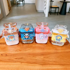Detail of four cute cartoon square water bottles with straws and straps for kids