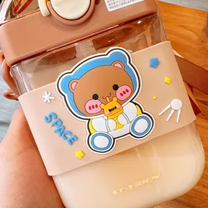 Detailed view of a square portable kids straw cup with a cute bear astronaut design