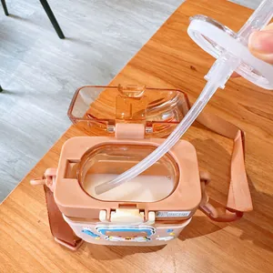 Detail view showing the straw and interior of a cute bear-themed square plastic sippy cup