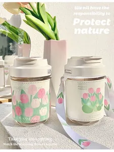Aesthetic glass water bottle with beautiful tulip pattern leather sleeve and strap