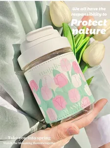 Close-up of glass water bottle with a floral tulip patterned leather sleeve