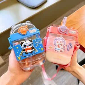 Close-up of two cute cartoon square plastic water bottles with straws and adjustable straps