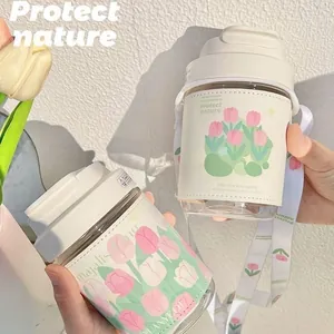 Close-up of fresh tulip patterned glass water bottles with portable straps