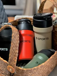 Detailed view of colorful sports insulated mugs with dual drink lids inside a woven basket