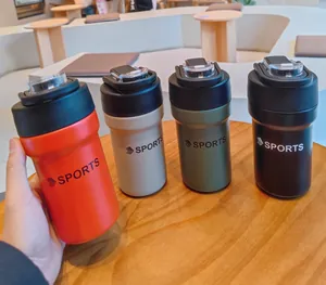Detailed view of four colorful stainless steel insulated sports bottles on a table