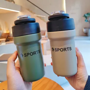 Two hands holding green and beige stainless steel sports water bottles with straw lids