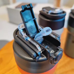 Close-up detail of the flip-top lid and silicone straw on the insulated water bottle.