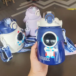 Detailed view of three colorful astronaut-themed stainless steel insulated water bottles.